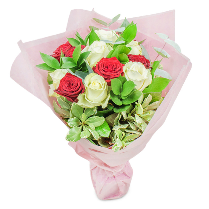 Capturing the graceful spirit of Highams Park, this hand-tied bouquet exudes both opulence and sincerity. Twenty roses-ten in dazzling white to convey purity, ten in lush, deep red for ardour-form its dramatic heart. Each rose is pristine, with tightly furled petals suggesting peak freshness, and strategically mixed to showcase contrast and harmony. Swathes of verdant, glossy ruscus, rounded pale-green leaves, architectural sprigs of eucalyptus, and creamy-edged variegated foliage surround the blooms, their layered textures reminiscent of the tranquil woodlands near Highams Park Lake. Wrapped with care in multiple sheets of diaphanous pastel pink paper, the bouquet is gathered and tied with precision, evoking the delicate hues glimpsed throughout The Highams Estate in spring. Soft morning light glints across the composition, highlighting both the complexity and expert craftsmanship of a local florist who knows each blossom's place: the warmth of the reds, the calm of the whites, the lush backdrop of living green. The subtle rose fragrance mingles with leafy freshness, and the gently domed silhouette suggests celebration-ideal for marking anniversaries, sharing love, or enriching community events in and around E4. This floral gift, prepared with heartfelt attention to Highams Park traditions, speaks eloquently of devotion, joy, and genuine local artistry-a true reflection of thoughtful floristry.
