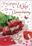 The image portrays an anniversary card styled as an intimate vignette that could easily be imagined on a sideboard in a Highams Park home after a surprise delivery. At the centre, a cluster of luscious red roses spills gently across the surface, each bloom dense with velvety petals that transition from deep, shadowed crimson at their heart to softly illuminated edges. Surrounding the roses is a spray of fresh greenery, the leaves smooth and glossy, adding contrast and a sense of natural vitality that recalls a stroll through the green spaces around Highams Park. Close by rests an inviting envelope, its clean, pale surface promising a heartfelt, handwritten message carefully folded inside. A heart-shaped keepsake box, finished in a bold, romantic red, nestles beside a delicate piece of jewellery whose metal and possible gemstones catch and reflect the light with refined sparkle. Scattered around these focal elements are small heart motifs and jewel-like embellishments, arranged so they shimmer gently rather than dazzle, contributing to the sense of celebration. A single butterfly motif appears near the roses, its presence adding a hint of whimsy and renewal, like a quiet symbol of how love evolves over time. The text on the card is rendered in graceful cursive script, its lines weaving among the decorations in a way that feels personal and warm. Soft lighting washes over the entire arrangement, making the reds richer and the metallic details warmer, while creating subtle shadows that lend depth. The result is a scene that captures the spirit of an anniversary marked with thoughtful gestures, much like a carefully chosen bouquet from a trusted Highams Park florist.